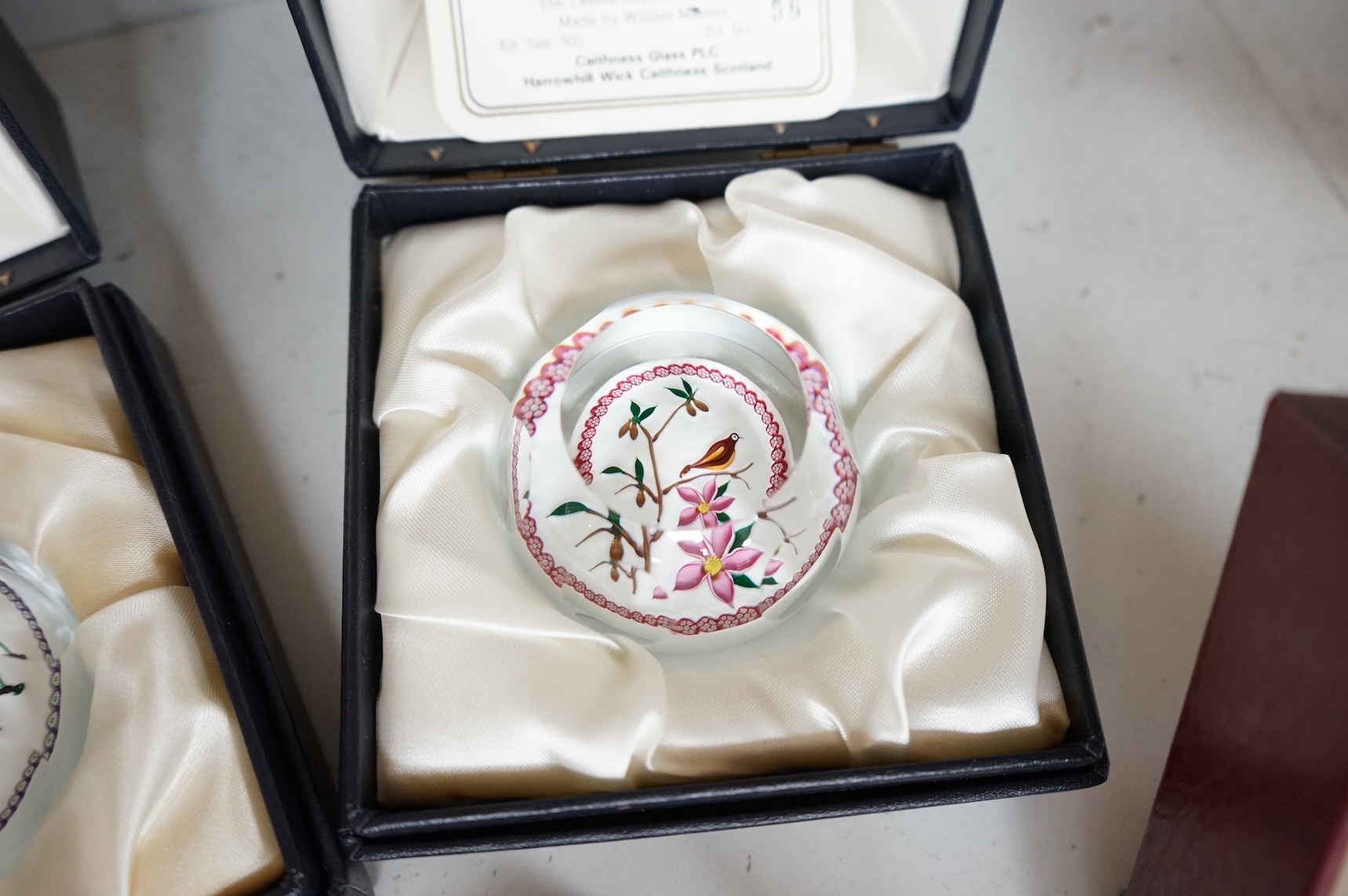 A group of five Caithness limited edition glass paperweights; highland fling, 01/250, Partridge in a pear tree, 56/500, Millefiori crown, 221/500, Rona, 56/500, Royal Birthday crown, 118/250 together with a moon crystal